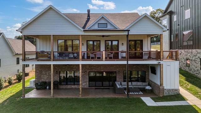 rear view of house with a lawn, an outdoor living space, a balcony, and a patio