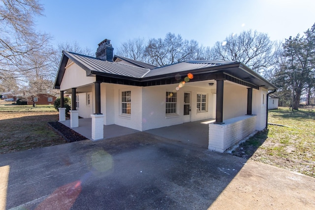 view of home's exterior with a porch and a patio