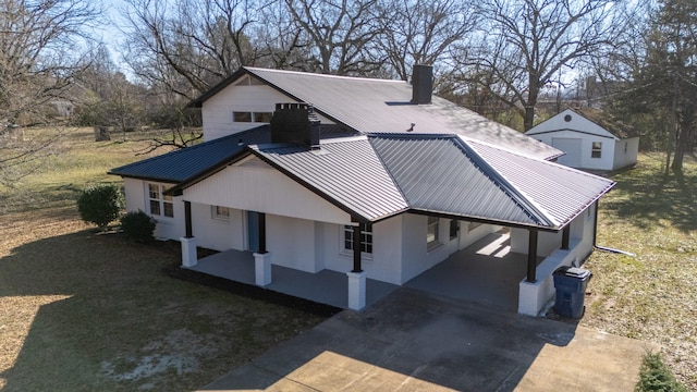 exterior space with a yard, covered porch, and a carport