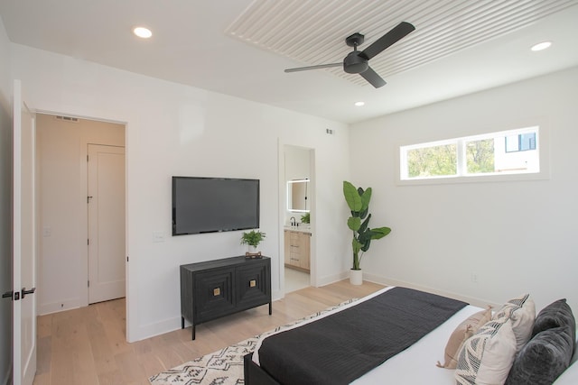 bedroom with light hardwood / wood-style floors, ensuite bath, and ceiling fan