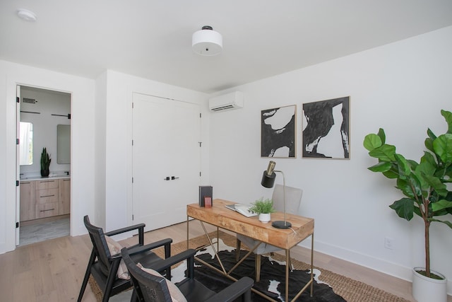 office area featuring light hardwood / wood-style flooring and a wall unit AC