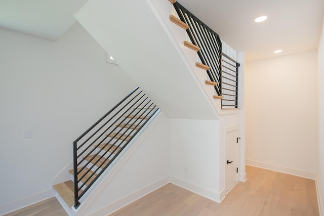 stairs featuring hardwood / wood-style floors