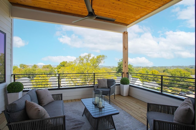 balcony with an outdoor living space and ceiling fan