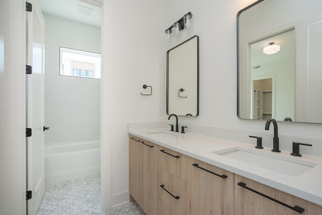 bathroom featuring tile patterned floors, vanity, and shower / bathing tub combination