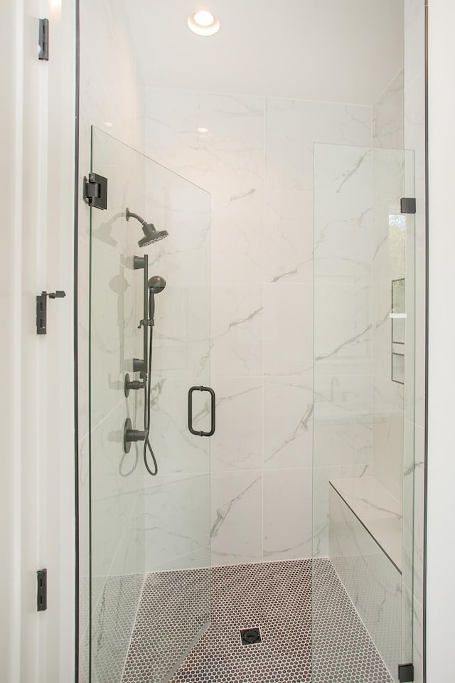 bathroom with a shower with door