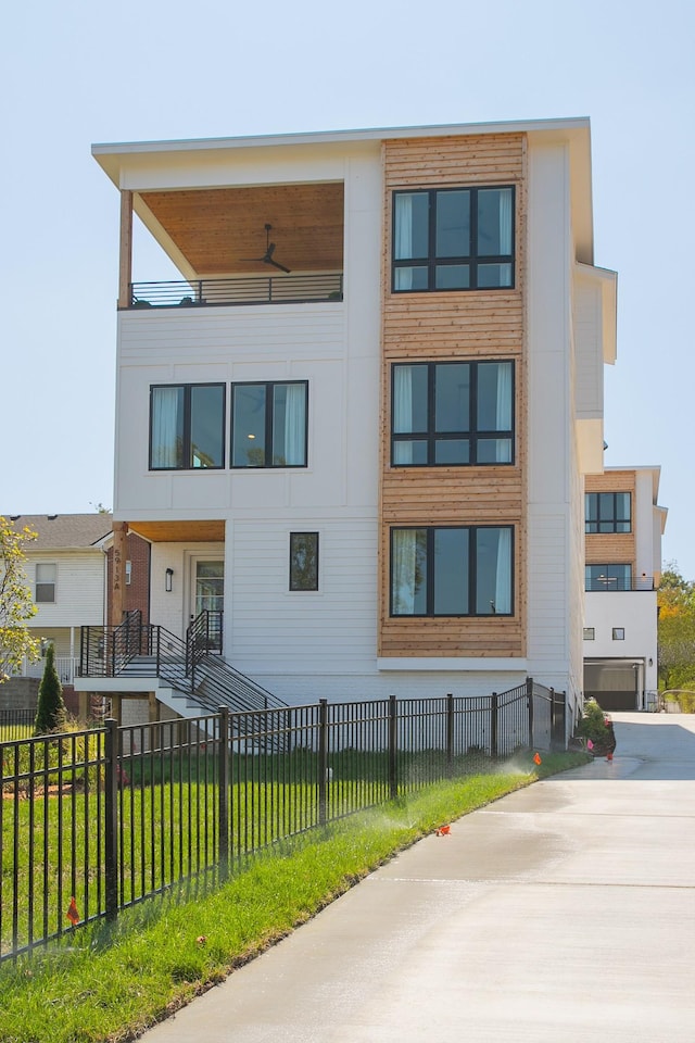 exterior space with ceiling fan and a yard