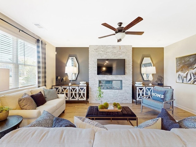 living room with ceiling fan and light hardwood / wood-style floors