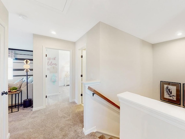 hallway featuring light colored carpet