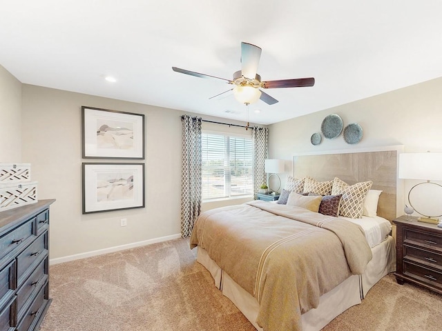 bedroom featuring light carpet and ceiling fan