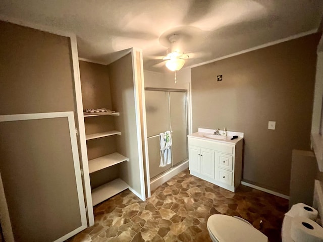 bathroom featuring walk in shower, vanity, toilet, and ceiling fan