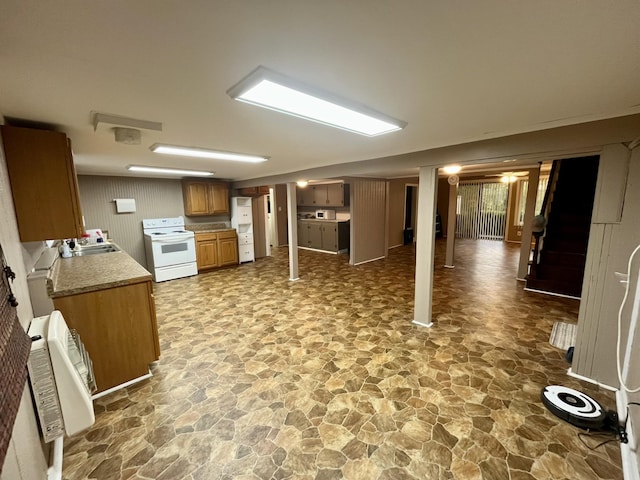 kitchen featuring sink, heating unit, and electric stove