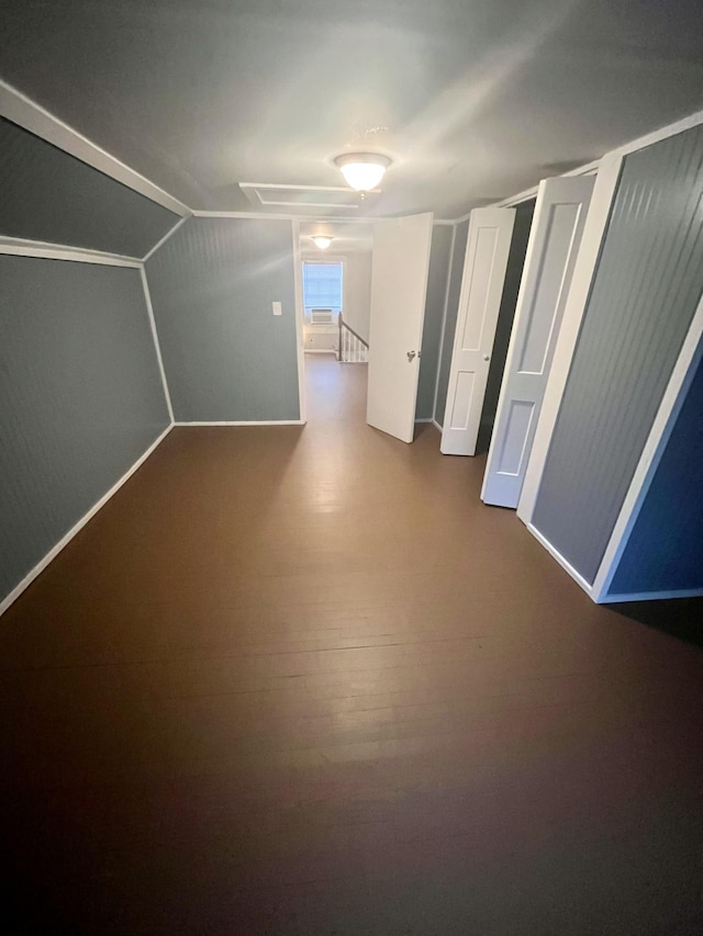 additional living space featuring hardwood / wood-style floors and lofted ceiling