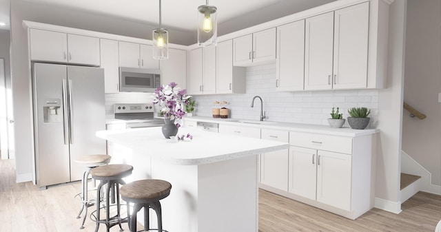 kitchen featuring sink, white cabinets, hanging light fixtures, and appliances with stainless steel finishes