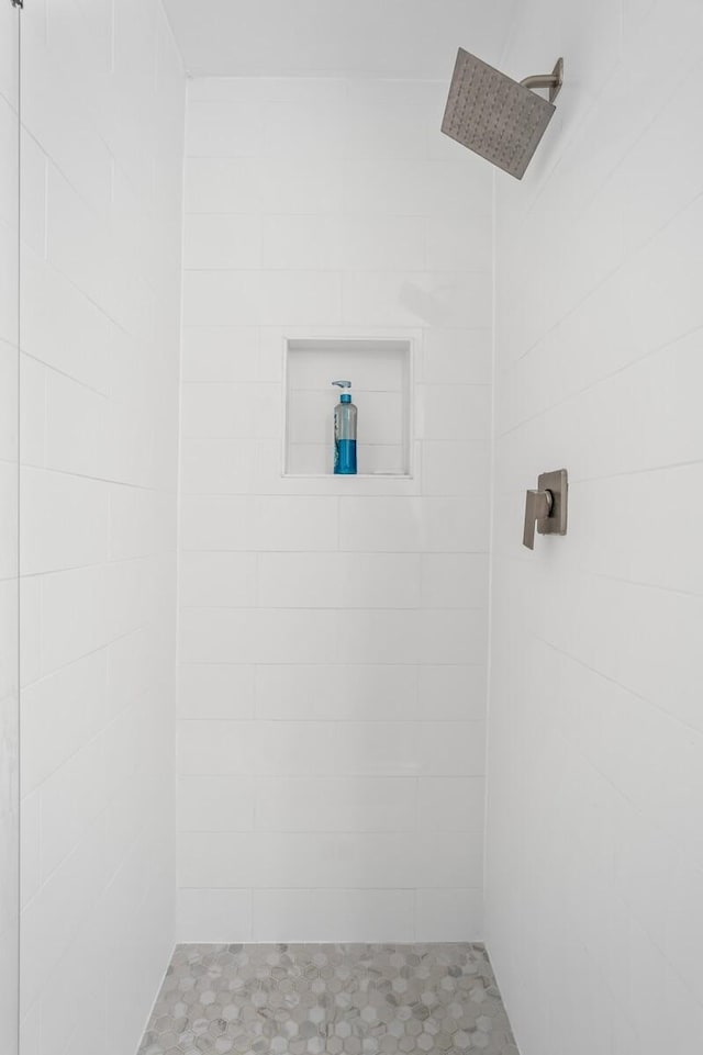 bathroom with a tile shower