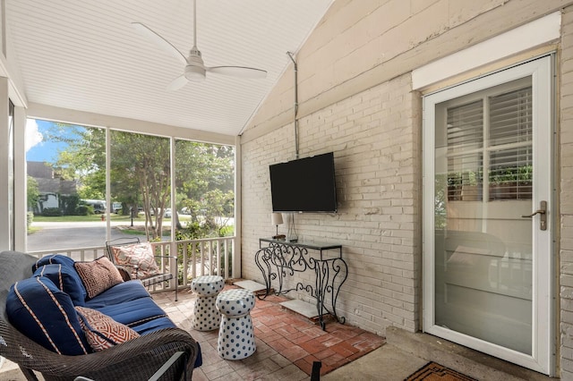 sunroom / solarium with ceiling fan and vaulted ceiling