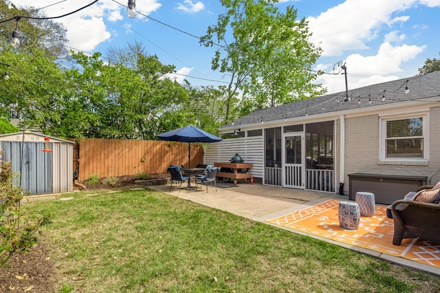 view of yard with a patio, a storage shed, and a sunroom