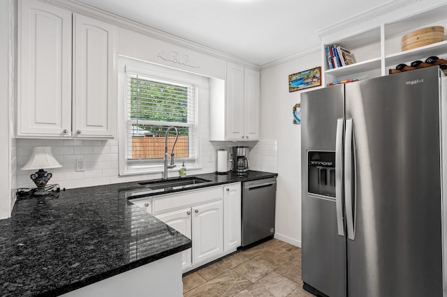 kitchen with dark stone counters, sink, appliances with stainless steel finishes, tasteful backsplash, and white cabinetry