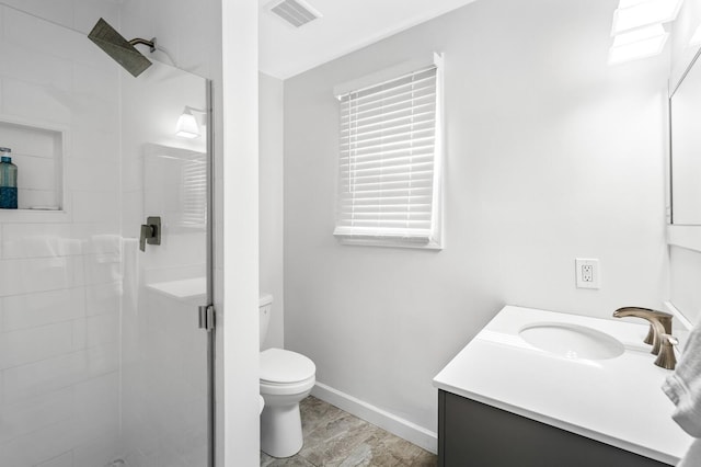 bathroom with vanity, toilet, and an enclosed shower