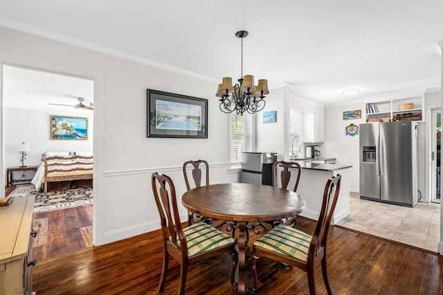 dining room featuring ceiling fan with notable chandelier, light wood-type flooring, and ornamental molding