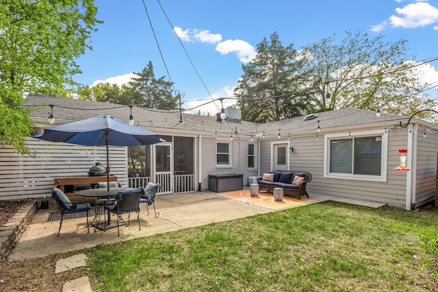 back of property with outdoor lounge area, a patio, a sunroom, and a lawn