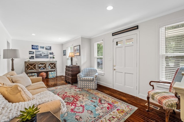 living room featuring ornamental molding, dark hardwood / wood-style floors, and a healthy amount of sunlight