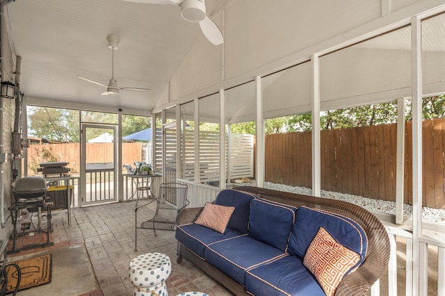 sunroom / solarium featuring ceiling fan and vaulted ceiling