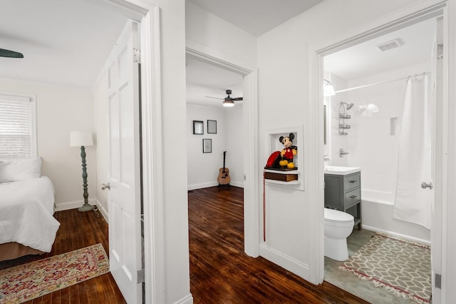 full bathroom featuring tub / shower combination, vanity, ceiling fan, hardwood / wood-style flooring, and toilet