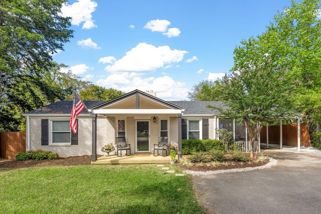 view of front of property with a porch and a front lawn