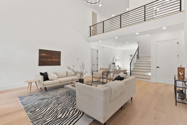 living room featuring a high ceiling and light wood-type flooring