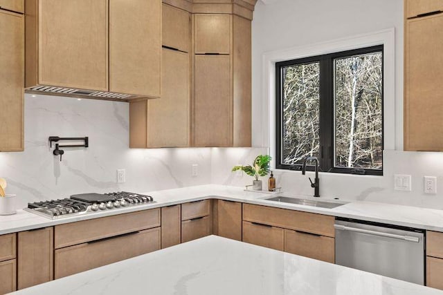 kitchen featuring tasteful backsplash, sink, stainless steel appliances, and light brown cabinetry