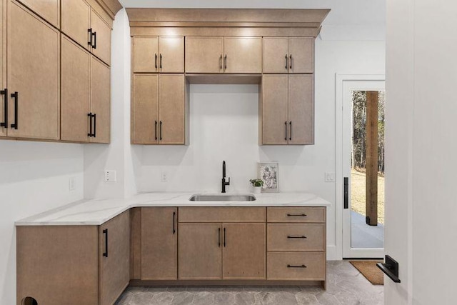 kitchen featuring crown molding and sink