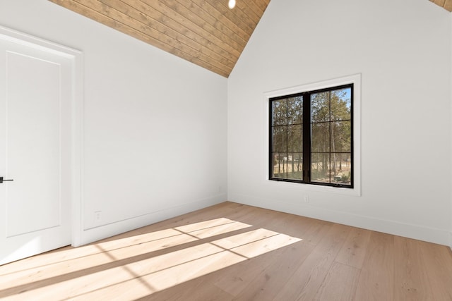 spare room featuring high vaulted ceiling, wooden ceiling, and light wood-type flooring