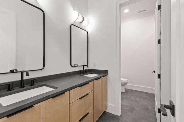 bathroom featuring vanity, toilet, and tile patterned flooring