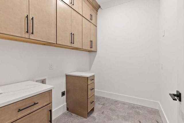 laundry room with cabinets, electric dryer hookup, and washer hookup