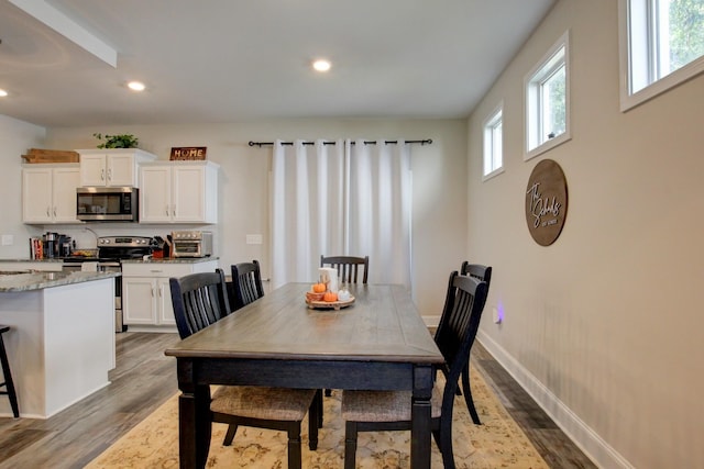 dining area with hardwood / wood-style flooring