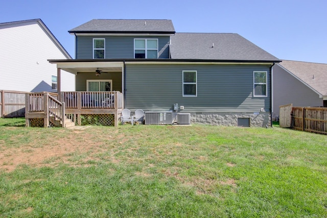 back of property with central AC, a deck, ceiling fan, and a lawn