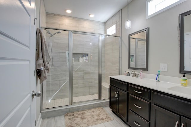 bathroom with vanity, tile patterned floors, and a shower with door