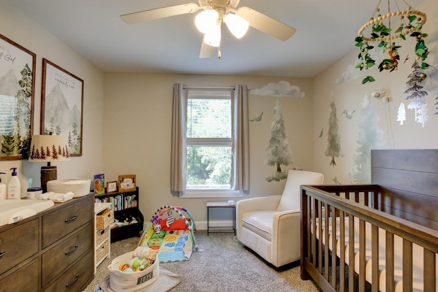 carpeted bedroom with a crib, ceiling fan, and sink