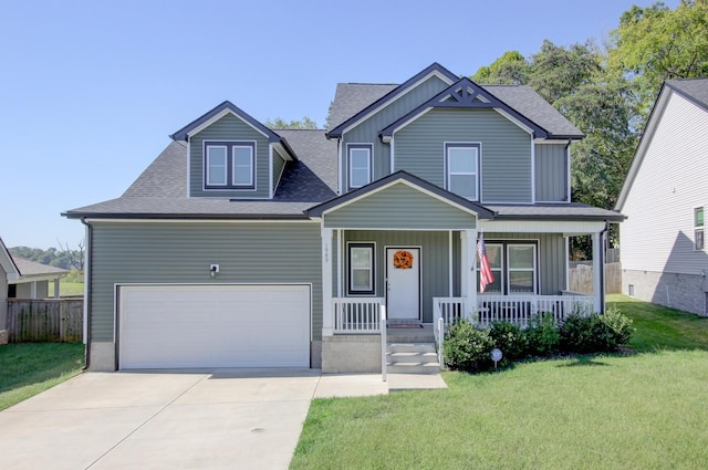 view of front of home featuring a porch, a garage, and a front lawn