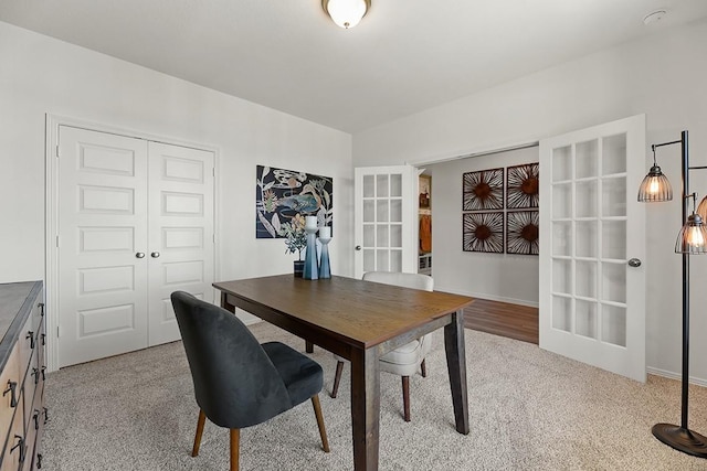 home office with light colored carpet and french doors