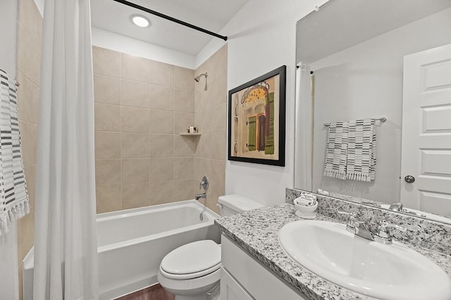 full bathroom featuring shower / bath combo with shower curtain, vanity, and toilet