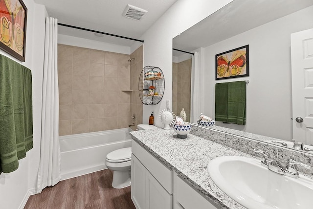 full bathroom with vanity, toilet, wood-type flooring, and shower / tub combo with curtain