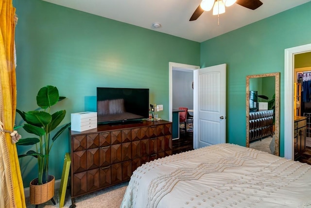 carpeted bedroom featuring connected bathroom and ceiling fan