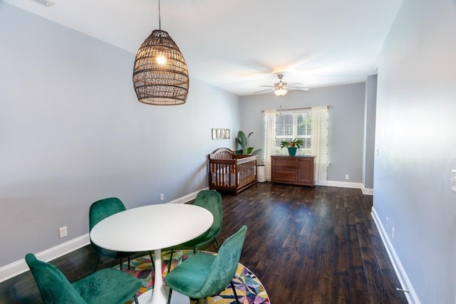 dining room with ceiling fan and dark wood-type flooring