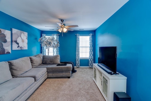 carpeted living room with ceiling fan