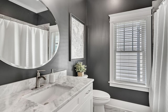 bathroom featuring vanity, toilet, and ornamental molding