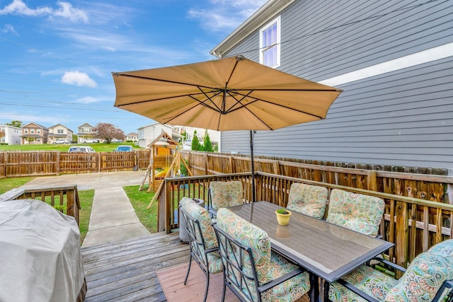 wooden terrace with an outdoor living space, a grill, and a playground