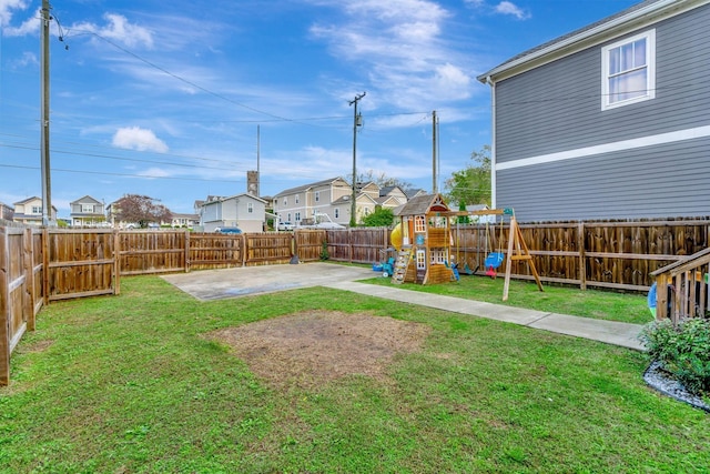 view of yard featuring a playground and a patio