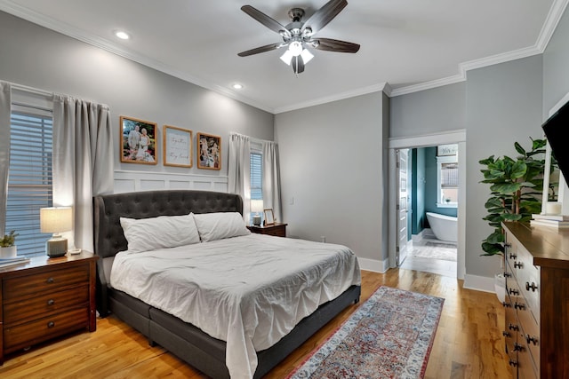 bedroom with multiple windows, light hardwood / wood-style flooring, ensuite bath, and ceiling fan