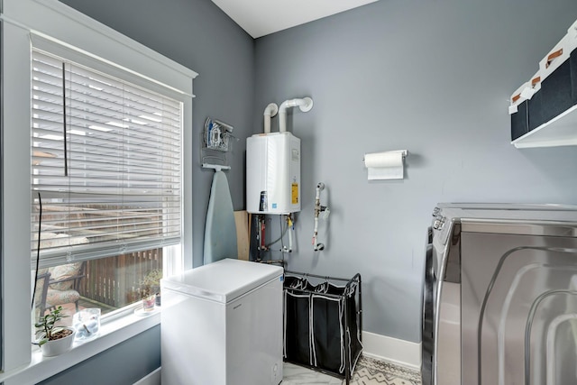 laundry room featuring washing machine and dryer and water heater